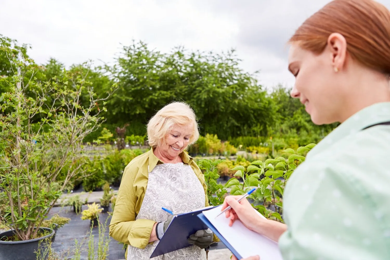 two,gardener,women,with,checklist,make,inventory,or,write,down